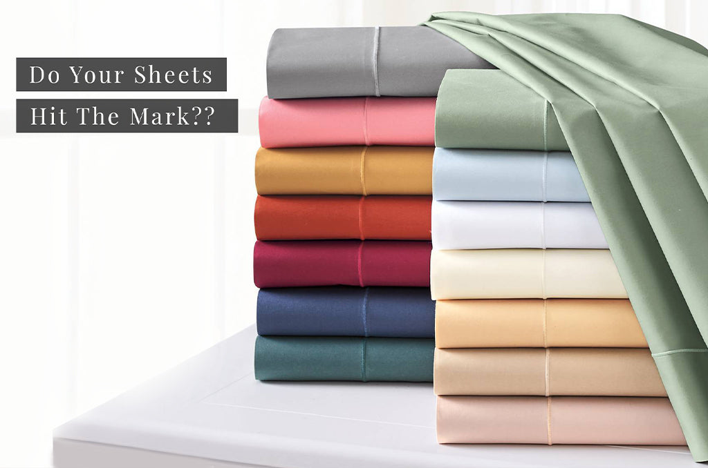 Stack of colorful Pizuna cotton bed sheets displayed to illustrate quality bedding standards